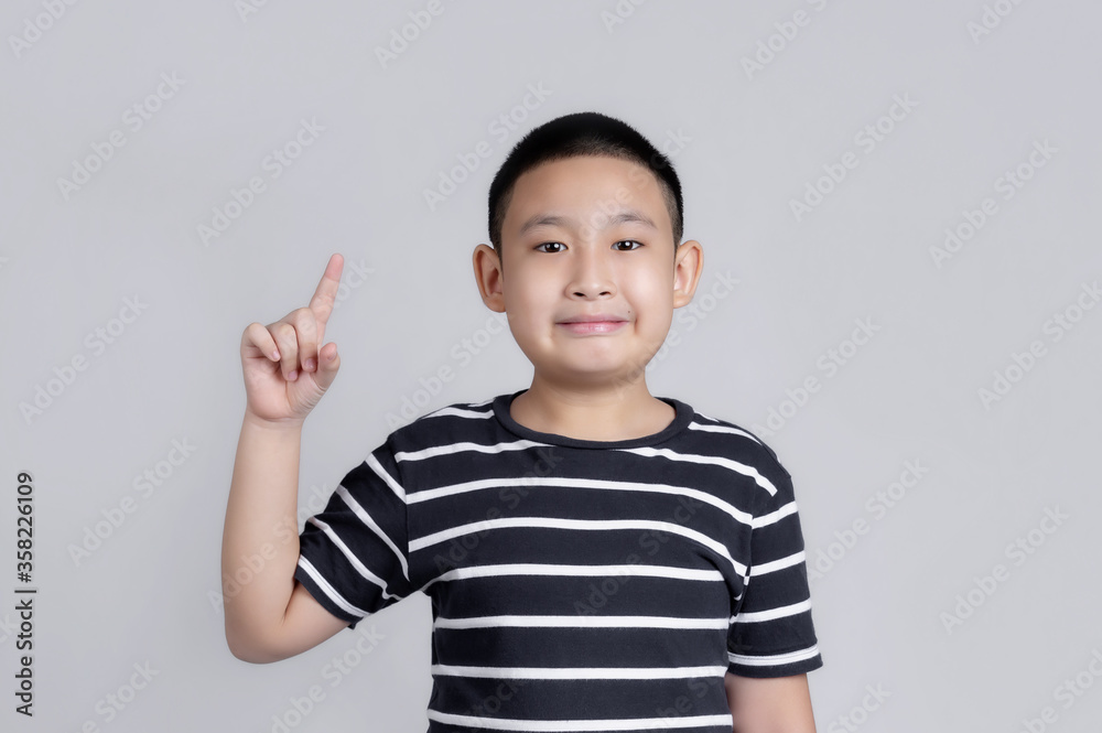 Portrait of happy Asian boy showing thumbs-up gesture. Portrait of happy Asian boy showing thumbs-up gesture.
