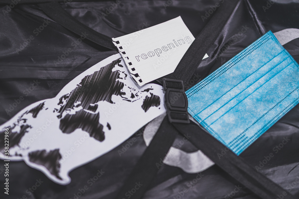 Foto de flying during covid19, carryon luggage with surgical face