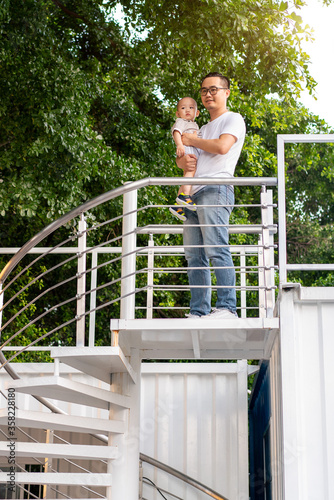 Young Asian father and son on the street