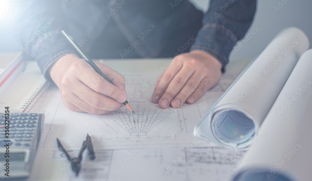 Architect working on blueprint. Architects workplace - architectural ...