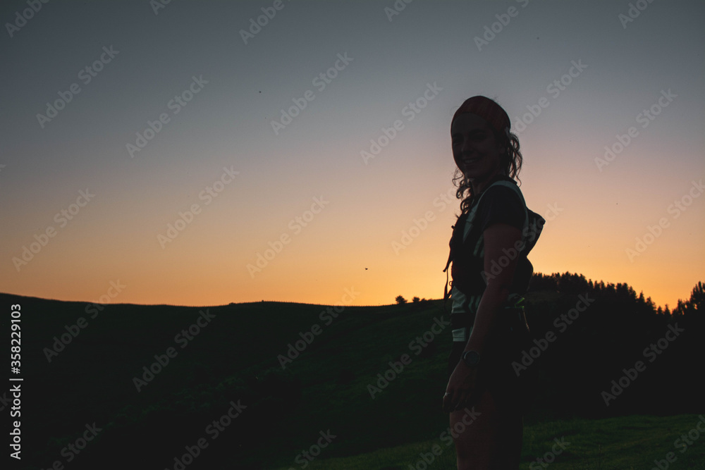 silhouette of a young woman in the mountains