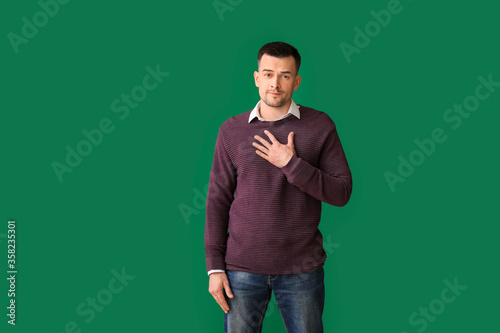 Photos Portrait of apologizing man on color background