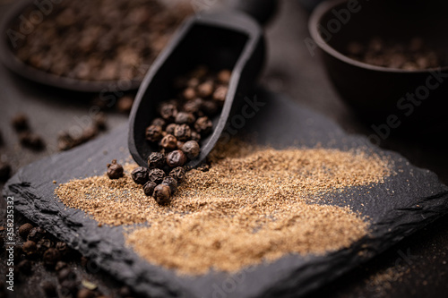 whole and milled black pepper photo