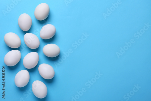 Fresh chicken eggs on color background