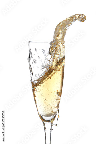 Glass of champagne with splash on white background