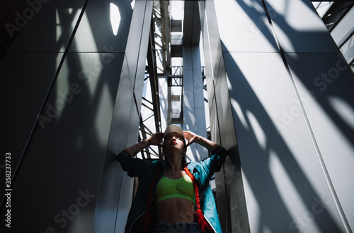 Young woman among iron columns