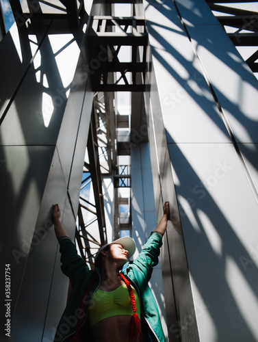 Young woman among iron columns