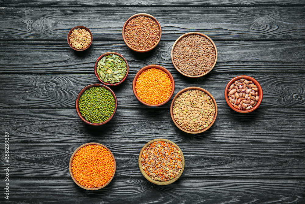 Bowls with raw legumes on table Bowls with raw legumes on table