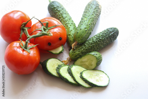 cucumbers and tomatoes on a white background close up