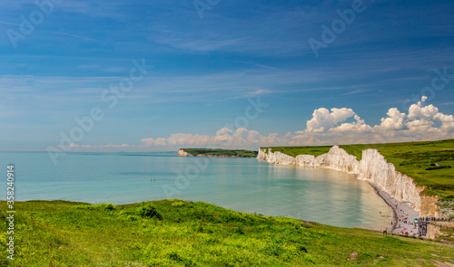 Fototapeta Naklejka Na Ścianę i Meble -  Amazing seascape of Birling Gap beach at East Sussex in UK with beautiful blue sky and view to Seven Sisters white cliffs,Birling Gap East Sussex UK