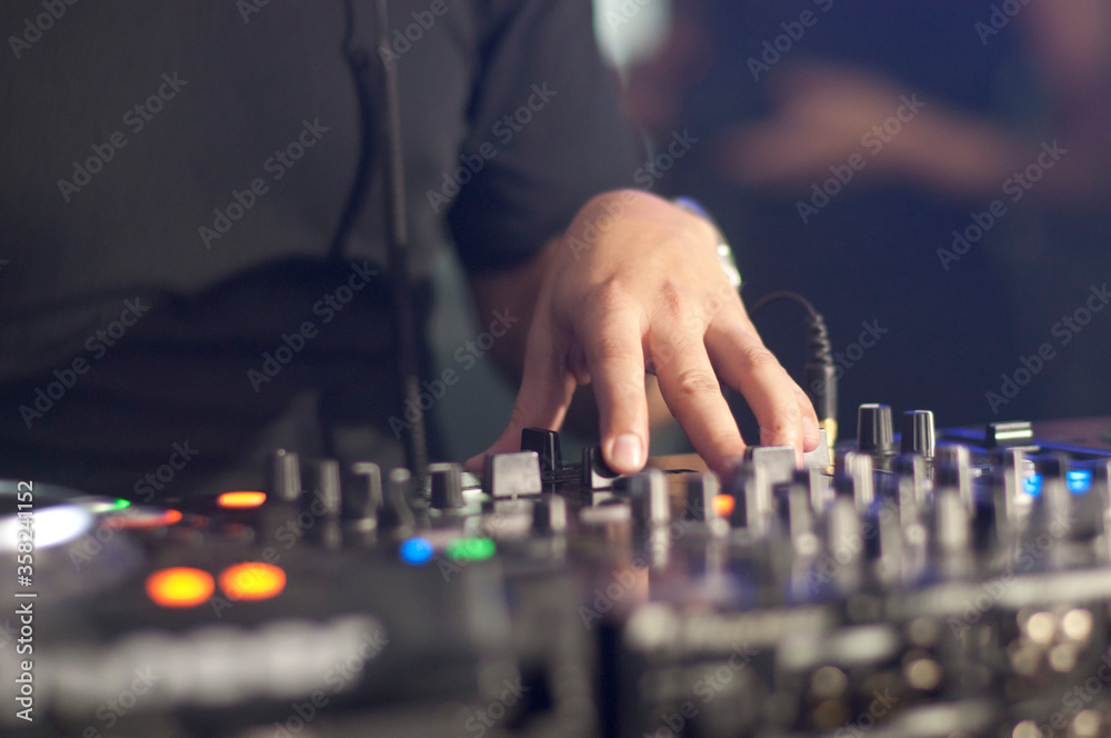 DJs hands on audio system mixing music in a party DJs hands on audio system mixing music in a party