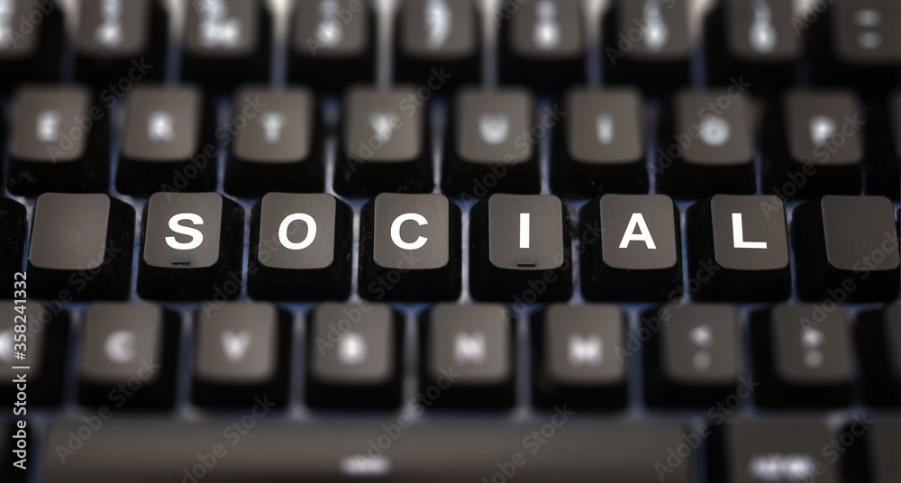 Social media concept. Social text written on keypad. Black keys with white letters message for global digital communication on pc keyboard. Blur buttons background. Social media concept. Social text written on keypad. Black keys with white letters message for global digital communication on pc keyboard. Blur buttons background.