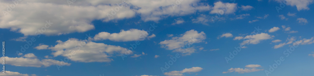Beautiful blue skies with white fluffy clouds in the daytime. Panoramic view. Beautiful blue skies with white fluffy clouds in the daytime. Panoramic view.