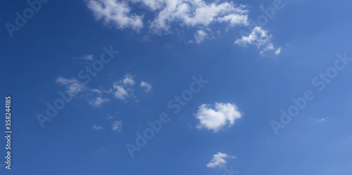 Beautiful blue skies with white fluffy clouds in the daytime. Panoramic view.