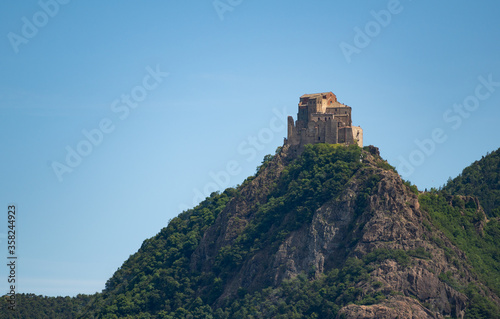 View of the Abbey of San Michele della Chiusa,Piedmont, Italy. Footage from the mountain on the opposite side of the valley, this abbey perched at the top of the peak has an imposing appearance.