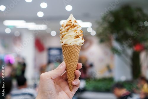 Hokkaido milk and cheese soft ice cream. A wafer cone of milk and cheese ice cream soft serve topped with crispy nut.