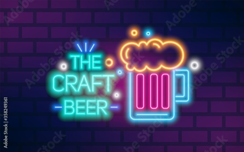 Bright glowing neon light the craft beer sign vector flat illustration. Colorful glass mug with foamy malt beverage isolated on brick wall background. Signboard with design elements of bar or pub