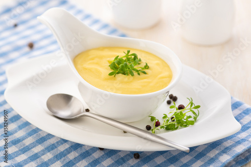 Hollandaise sauce. Classic French cuisine sauce. Emulsion sauce of butter and egg yolks with vinegar.