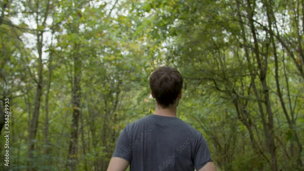Young Athletic Man jogging/walking in the Forest Young Athletic Man jogging/walking in the Forest