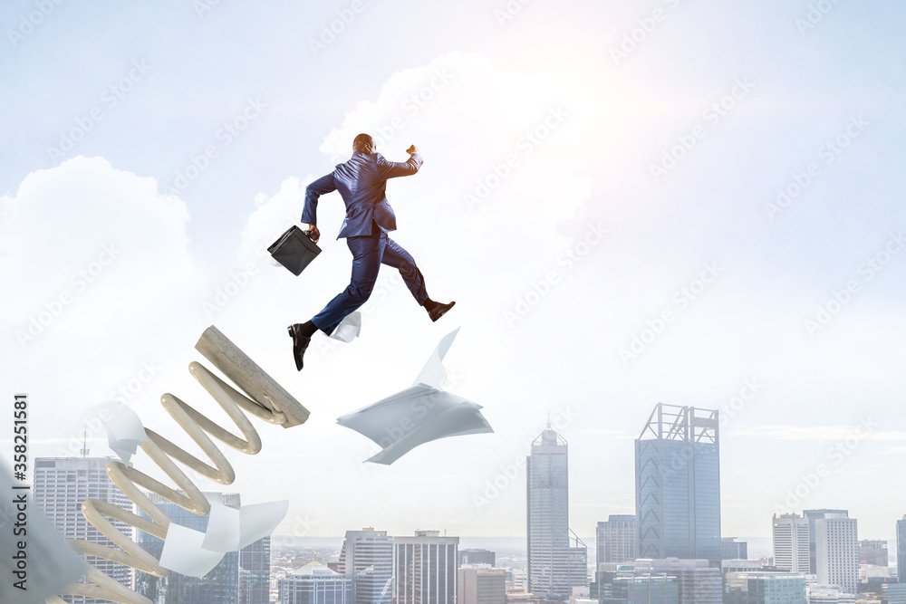 Businessman jumping on springboard . Mixed media Businessman jumping on springboard . Mixed media