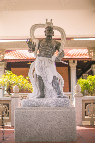 A statue of Thunder God bên trong nghĩa trang in Long Thanh photo