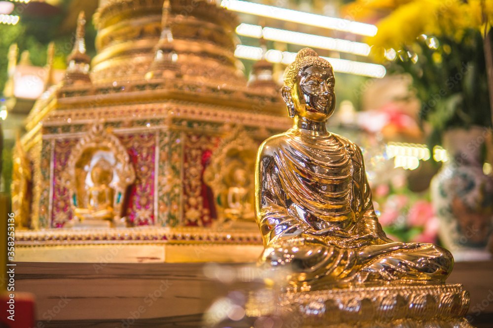 The Buddha image likes the shiny golden emulsion and the background is relic blurred