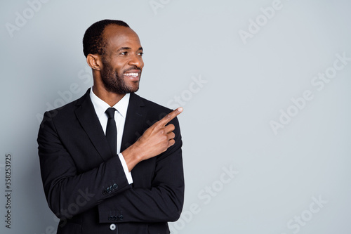 Close-up portrait of his he nice attractive cheerful cheery classy guy employee banker economist ceo boss chief showing decision ad advert advice copy space isolated over grey pastel color background
