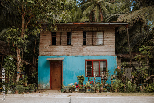 small colorful house in the philippines attached to the road
