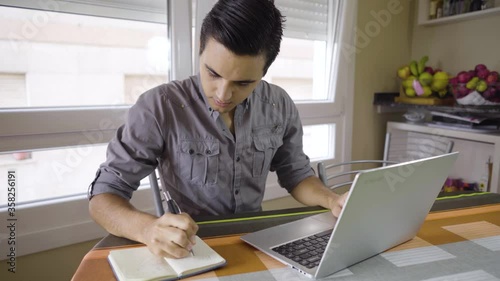 young boy working on laptop from home
