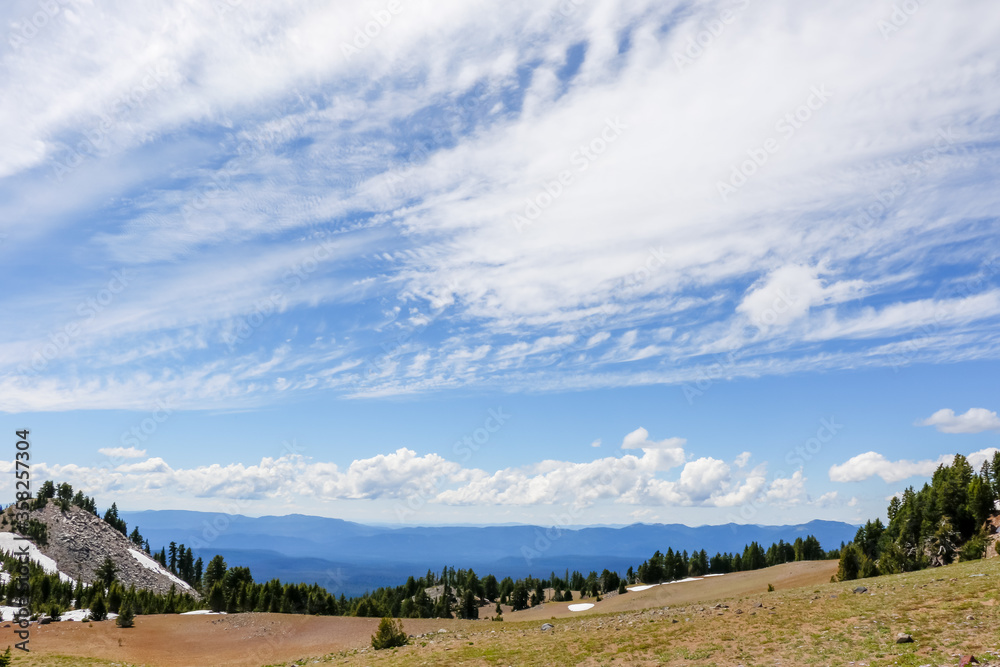 Snow on Mountain and Blue Sky in Summer at Crater Lake National Park, Oregon.