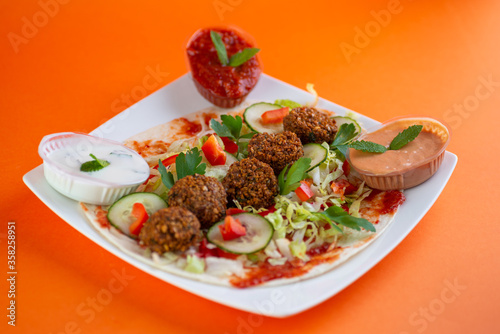 Falafel , middle eastern deep fried chickpea balls with french fries 