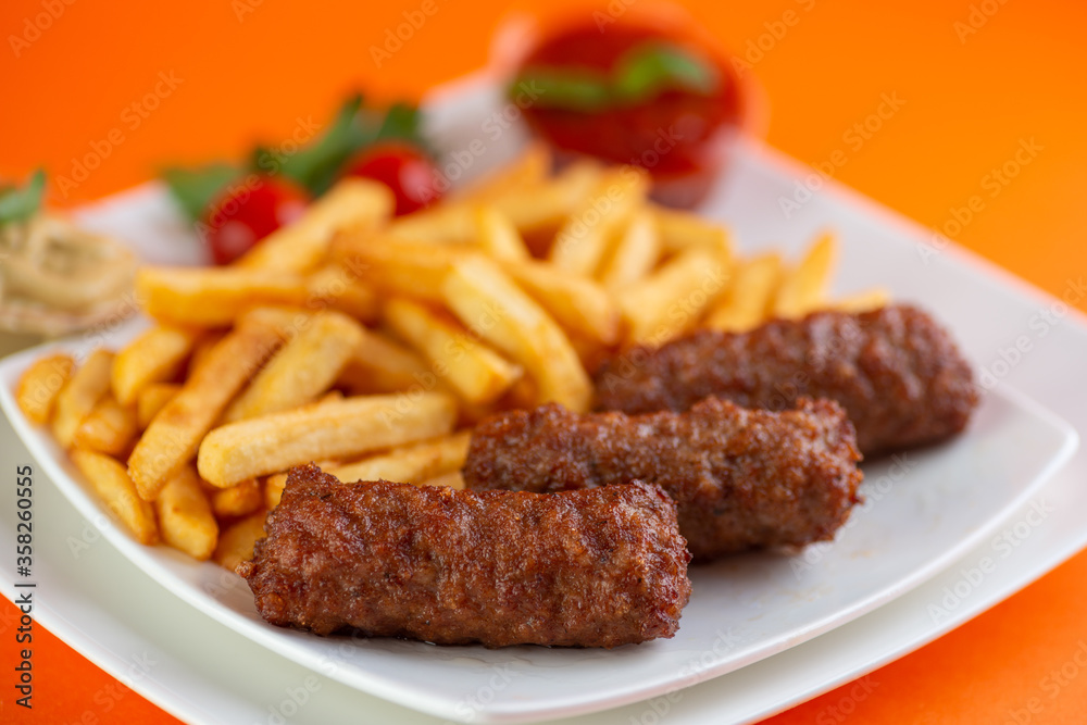 Traditional Romanian Dinner With Meatballs Or Mici And French Fries