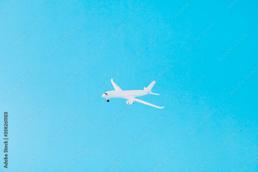 Picture of nice white aircraft plane flying cruise world exploring clear light sky isolated over bright vivid shine vibrant blue color background Picture of nice white aircraft plane flying cruise world exploring clear light sky isolated over bright vivid shine vibrant blue color background