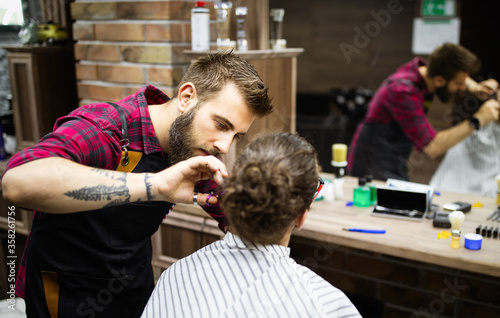 Client during beard and moustache grooming in barber shop