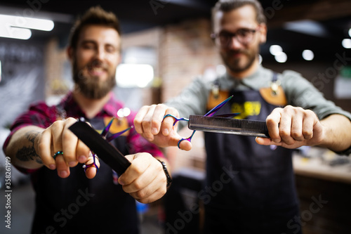 Portrait of young male barbers and hairdressers in barber shop
