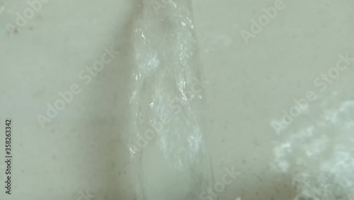 clean water flows out of the pipe