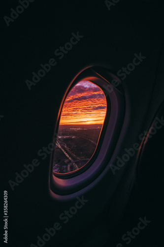 Photography windows plane with sunset and clouds flying
