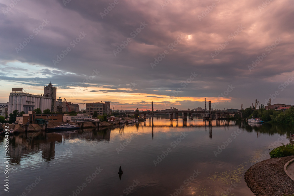 Kiev (Kyiv), Ukraine - June 15, 2020: Dnipro river and industrial area during the sunset