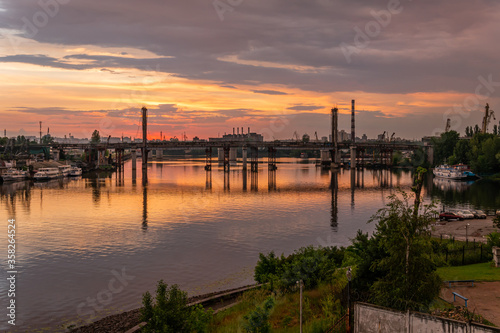 Kiev (Kyiv), Ukraine - June 15, 2020: Dnipro river and industrial area during the sunset