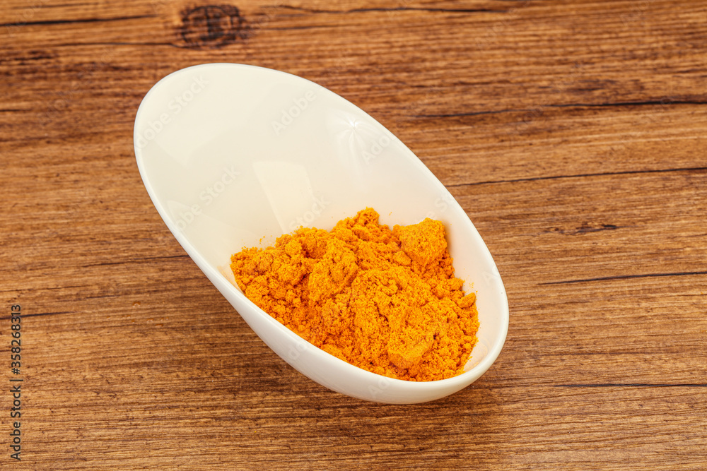 Tumeric powder in the bowl Tumeric powder in the bowl
