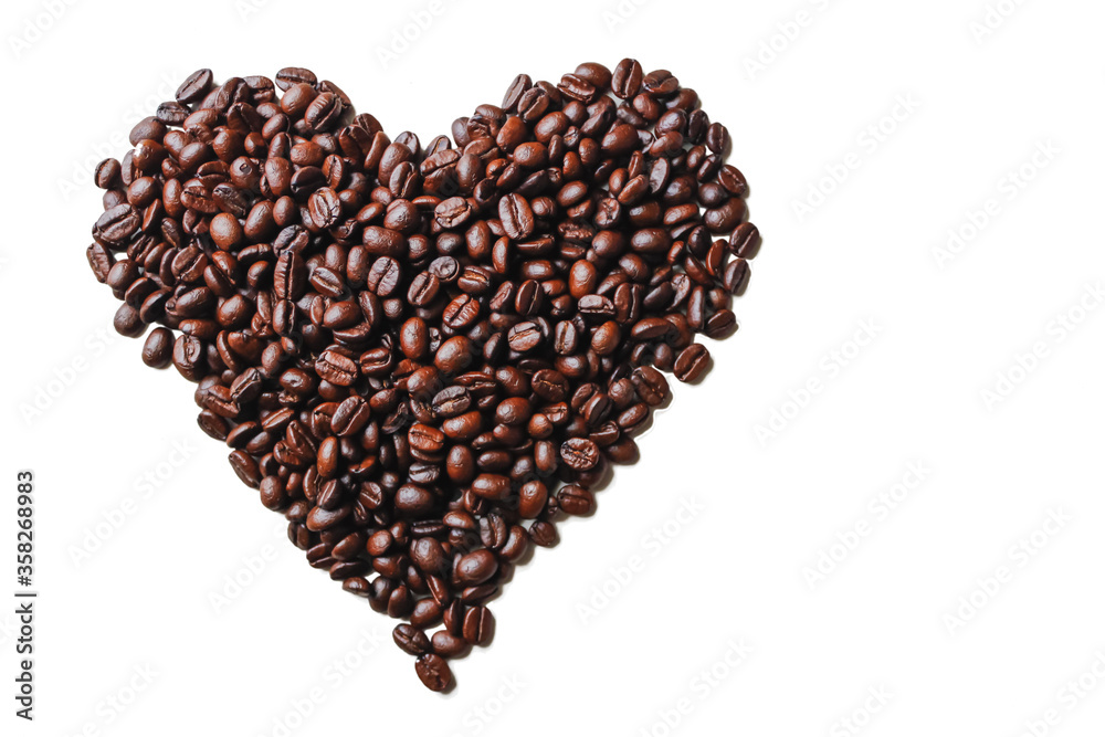 Black roasted coffee beans are arranged on a white background in a heart shape to show the symbol of love, friendship and kindness. The concept of symbolizing friendship and love with coffee beans Black roasted coffee beans are arranged on a white background in a heart shape to show the symbol of love, friendship and kindness. The concept of symbolizing friendship and love with coffee beans