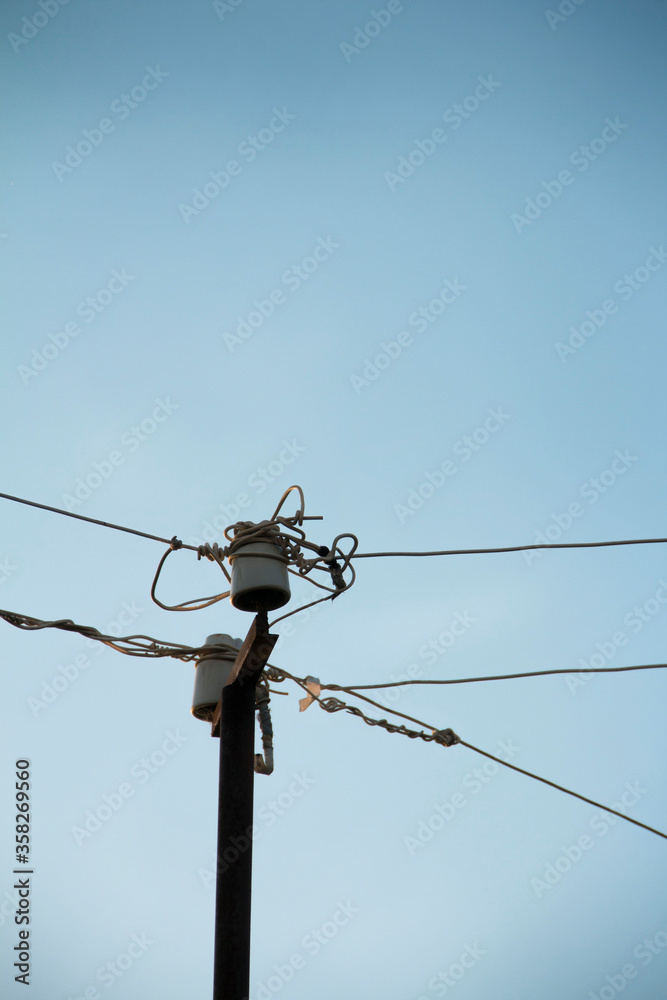 Obraz premium Electric wires against the blue sky