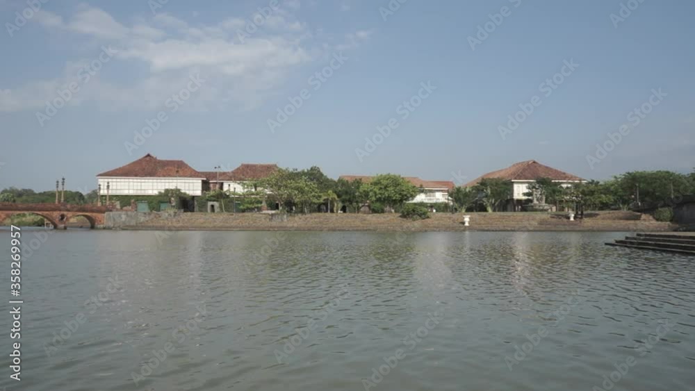 Scenic view of the river with old houses and bridge in the background, Las Casas Filipinas de Acuzar, Philippines, 60fps Scenic view of the river with old houses and bridge in the background, Las Casas Filipinas de Acuzar, Philippines, 60fps
