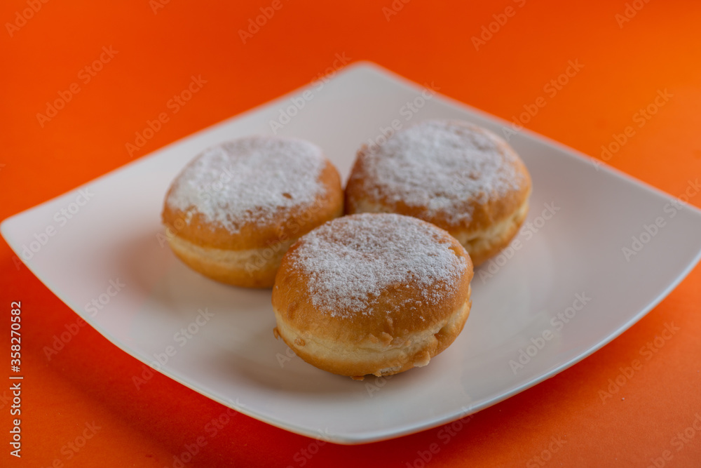 Yummy yellow dougnuts with granulated sugar.