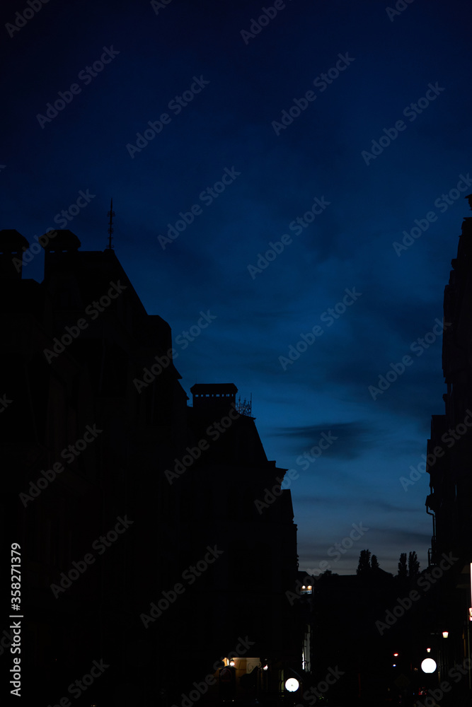 View of the night sky and the silhouettes of houses.
