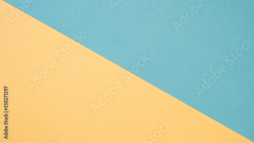 Textural background in trendy pastels: grey and rich yellow in a minimalistic concept. Flat lay, top view