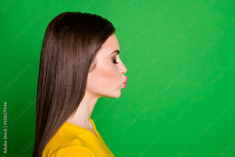 Fototapeta premium Close-up profile side view portrait of nice-looking attractive lovable affectionate dreamy straight-haired girl sending air kiss 14 February isolated bright vivid shine vibrant green color background