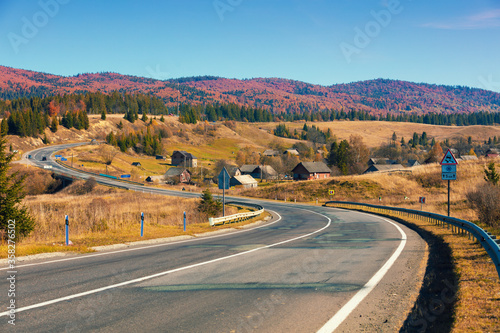 View of the mountain highway and village in autumn. Carpathian mountains. Ukraine