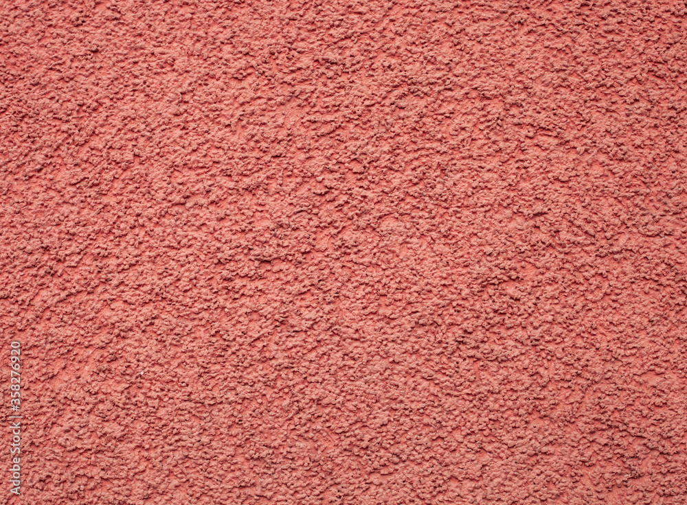Fototapeta premium Texture pink pebble dash stucco on house facade