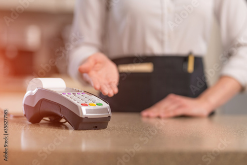 The waiter offers non-cash payment through a terminal, restaurant business or hotel, bank transfer
